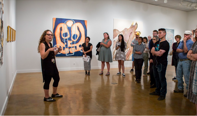 Instructor Irene Carvajal at the Pictorial Arts Faculty Exhibition walk-through in 2017.