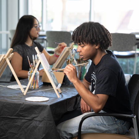 students painting at the wellness lounge